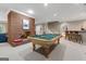 Basement game room and bar with brick fireplace and staircase at 9274 Betony Wood Trl, Jonesboro, GA 30236