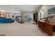 Finished basement with a treadmill, seating, and a classic wood desk at 9274 Betony Wood Trl, Jonesboro, GA 30236