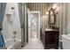 Classic bathroom with shower, marble vanity, decorative sconces and access to bedroom at 9274 Betony Wood Trl, Jonesboro, GA 30236