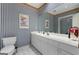 Bathroom with blue and white checkered wallpaper, mirror, and vanity at 9274 Betony Wood Trl, Jonesboro, GA 30236
