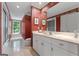 Elegant bathroom with red wallpaper, vanity, and window seat at 9274 Betony Wood Trl, Jonesboro, GA 30236