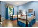Charming bedroom with hardwood floors, two beds with ornate bedding, and ample natural light at 9274 Betony Wood Trl, Jonesboro, GA 30236