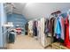 Organized walk-in closet provides ample storage space with shelving at 9274 Betony Wood Trl, Jonesboro, GA 30236