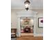 Dining room entrance featuring decorative columns and a chandelier, as viewed from an adjacent space at 9274 Betony Wood Trl, Jonesboro, GA 30236