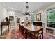 Dining room with hardwood floors and an elegant chandelier with a view to another room at 9274 Betony Wood Trl, Jonesboro, GA 30236
