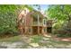 An exterior view of this brick home shows covered terraces and manicured lawn at 9274 Betony Wood Trl, Jonesboro, GA 30236