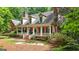Charming brick home with a welcoming front porch and manicured landscaping at 9274 Betony Wood Trl, Jonesboro, GA 30236