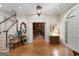 Elegant foyer featuring hardwood floors, staircase, and an entrance to the living room at 9274 Betony Wood Trl, Jonesboro, GA 30236