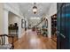 Spacious foyer with hardwood floors, elegant lighting, and a view into other rooms at 9274 Betony Wood Trl, Jonesboro, GA 30236