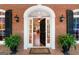 Elegant front entrance with a detailed door, sidelights, and potted ferns at 9274 Betony Wood Trl, Jonesboro, GA 30236