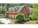 This three-car garage has a brick facade and dormer windows at 9274 Betony Wood Trl, Jonesboro, GA 30236