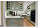 Stylish kitchen with custom cabinetry, white countertops, stainless steel appliances, and hardwood floors at 9274 Betony Wood Trl, Jonesboro, GA 30236