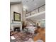 Spacious living room featuring a grand fireplace, staircase, and light hardwood floors at 9274 Betony Wood Trl, Jonesboro, GA 30236