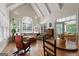 Open-concept living room with many windows and vaulted ceiling beams that allow for lots of natural light at 9274 Betony Wood Trl, Jonesboro, GA 30236