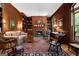 Cozy living room with wood-paneled walls, built-in bookshelves, and a fireplace at 9274 Betony Wood Trl, Jonesboro, GA 30236