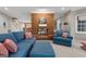 Living room featuring a brick fireplace, blue sofa, and decor at 9274 Betony Wood Trl, Jonesboro, GA 30236