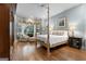 Spacious main bedroom with hardwood floors, bay windows and a four-poster bed at 9274 Betony Wood Trl, Jonesboro, GA 30236