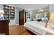 Sunlit main bedroom featuring built-in shelving, a bay window and hardwood floors at 9274 Betony Wood Trl, Jonesboro, GA 30236