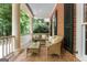 Inviting outdoor porch area with comfortable seating and a peaceful, wooded view at 9274 Betony Wood Trl, Jonesboro, GA 30236