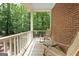 Inviting covered porch with rocking chairs, perfect for relaxing outdoors and enjoying the wooded view at 9274 Betony Wood Trl, Jonesboro, GA 30236