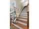 A carpeted stairway with a motorized chair to assist accessibility between floors at 9274 Betony Wood Trl, Jonesboro, GA 30236
