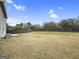 Spacious backyard with grass, a wooden fence, and mature trees at 789 Galveston Way, Mcdonough, GA 30253