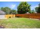 Expansive backyard featuring lush green grass, manicured landscaping, and a privacy fence at 208 Summer Chase, Carrollton, GA 30116