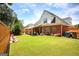 Large, well-kept backyard with a brick home, patio, and wooden fence, perfect for outdoor enjoyment at 208 Summer Chase, Carrollton, GA 30116