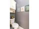 Cozy half bath featuring a toilet, gray walls and tasteful botanical wall art at 208 Summer Chase, Carrollton, GA 30116