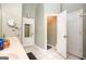 Bright bathroom featuring dual sinks, tiled floors, and multiple doors for convenient access at 208 Summer Chase, Carrollton, GA 30116