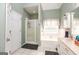 Inviting bathroom features a large soaking tub, walk-in shower, and natural light from the window at 208 Summer Chase, Carrollton, GA 30116