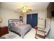 Comfortable bedroom with a queen-sized bed, ceiling fan, and a cozy rocking chair at 208 Summer Chase, Carrollton, GA 30116