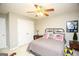 This bedroom features a ceiling fan, double closet, and American flag pillows at 208 Summer Chase, Carrollton, GA 30116