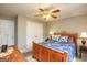 A cozy bedroom includes a wooden bed frame, patterned bedding, and a ceiling fan at 208 Summer Chase, Carrollton, GA 30116