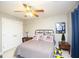Well-lit bedroom with American flag themed decor, ceiling fan, and a double door closet at 208 Summer Chase, Carrollton, GA 30116