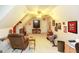 Bonus room offers a ceiling fan, TV, sloped ceilings and a seating area at 208 Summer Chase, Carrollton, GA 30116