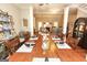 Bright dining room with a large wooden table and seating for eight, flowing into the living area at 208 Summer Chase, Carrollton, GA 30116