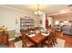 Cozy dining room with a large table, hardwood floors, and decorative shelving at 208 Summer Chase, Carrollton, GA 30116
