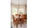 Cozy dining area with a wooden table, chairs, modern lighting, and large windows providing ample natural light at 208 Summer Chase, Carrollton, GA 30116