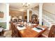 Open dining room features a large wooden table set for eight, adjacent to the living area and staircase at 208 Summer Chase, Carrollton, GA 30116