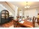 Elegant dining room features a wooden table set for eight, with a staircase and stylish cabinet nearby at 208 Summer Chase, Carrollton, GA 30116