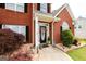Inviting entrance with a decorative wreath, manicured plants, and a paved walkway at 208 Summer Chase, Carrollton, GA 30116