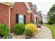 Close up view of a brick home with meticulous landscaping and a stone walkway at 208 Summer Chase, Carrollton, GA 30116