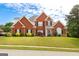 Beautiful two-story brick home featuring a well-manicured lawn and traditional architectural details at 208 Summer Chase, Carrollton, GA 30116