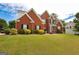 Inviting two-story brick home with well-maintained lawn and colorful shrubbery at 208 Summer Chase, Carrollton, GA 30116