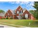 Charming two-story brick home featuring an immaculate lawn and mature landscaping at 208 Summer Chase, Carrollton, GA 30116