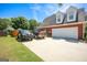 Spacious driveway leading to a two-car garage, with additional parking space and a well-kept lawn at 208 Summer Chase, Carrollton, GA 30116