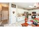 Bright kitchen with white cabinets, stainless steel appliances, granite countertops, and a view of a dining area at 208 Summer Chase, Carrollton, GA 30116