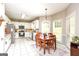 Bright kitchen features white cabinetry, stainless appliances, and a cozy dining area by the windows at 208 Summer Chase, Carrollton, GA 30116