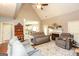 Spacious living room with a fireplace, plush seating, and an open view to the kitchen area at 208 Summer Chase, Carrollton, GA 30116
